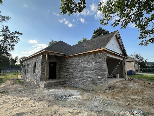 412 N 3rd St, Cabot, AR 72023 - view of property exterior featuring brick siding, a shingled roof, and a garage