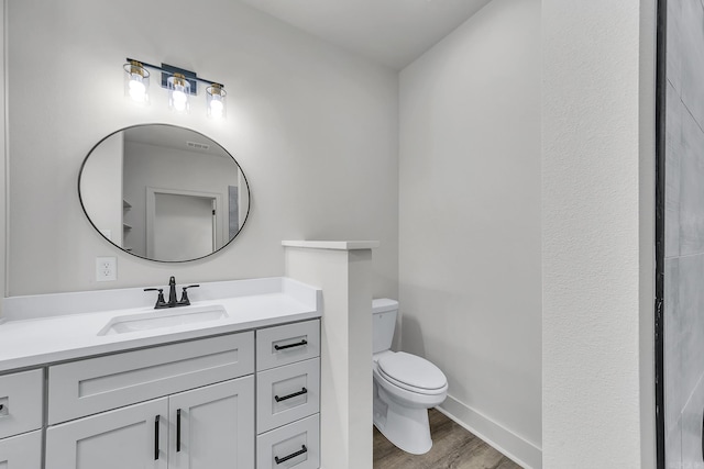 412 N 3rd St, Cabot, AR 72023 - bathroom featuring toilet, wood finished floors, vanity, and baseboards