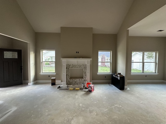 412 N 3rd St, Cabot, AR 72023 - living room featuring concrete flooring, lofted ceiling, baseboards, and a premium fireplace