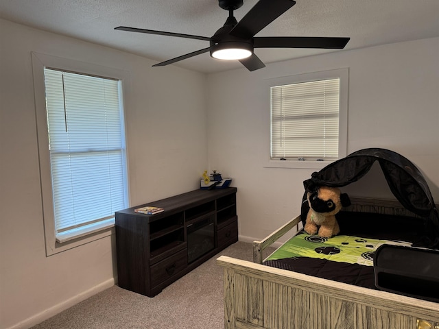 810 N Pear St, Searcy, AR 72143 - carpeted bedroom with baseboards, a ceiling fan, and a textured ceiling