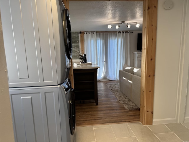 810 N Pear St, Searcy, AR 72143 - bathroom with stacked washer and clothes dryer, tile patterned floors, a textured ceiling, rail lighting, and vanity