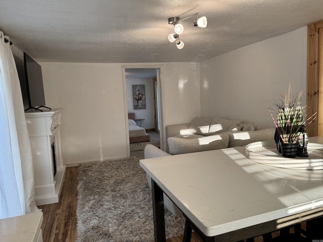 810 N Pear St, Searcy, AR 72143 - dining room with dark wood-style floors, a textured ceiling, and a fireplace