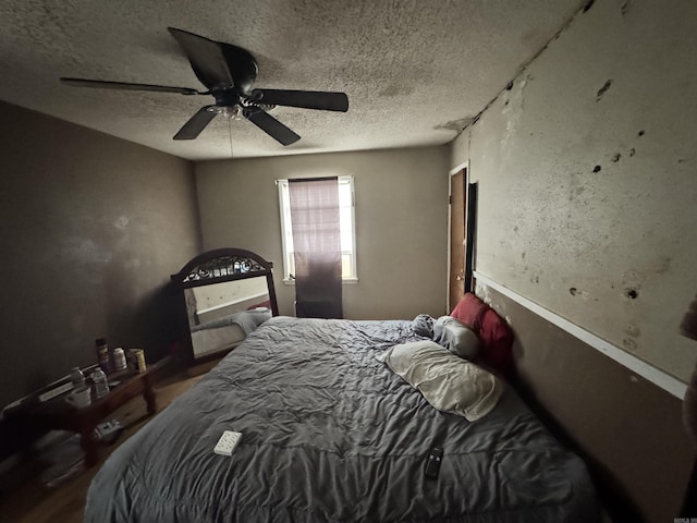 1416 Dogwood Trl, Malvern, AR 72104 - bedroom featuring a textured ceiling, a ceiling fan, and wood finished floors
