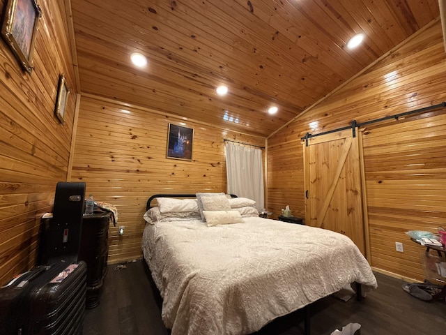 4579 Bayou Access Rd, Mammoth Spring, AR 72554 - bedroom featuring vaulted ceiling, a barn door, dark wood-type flooring, wooden ceiling, and wood walls