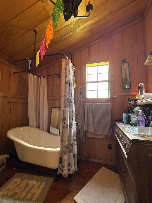 4579 Bayou Access Rd, Mammoth Spring, AR 72554 - bathroom with wood finished floors, a soaking tub, lofted ceiling, wooden walls, and a shower with shower curtain
