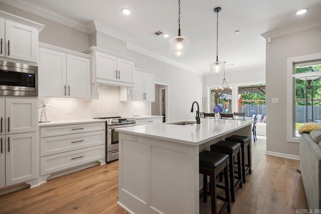 1449 Woolridge Dr, Benton, AR 72019 - kitchen with appliances with stainless steel finishes, recessed lighting, light wood-type flooring, backsplash, and light countertops