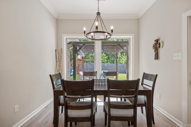 1449 Woolridge Dr, Benton, AR 72019 - dining space featuring a chandelier, wood finished floors, baseboards, and ornamental molding