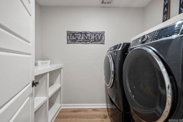 1449 Woolridge Dr, Benton, AR 72019 - laundry room with separate washer and dryer, wood finished floors, and baseboards