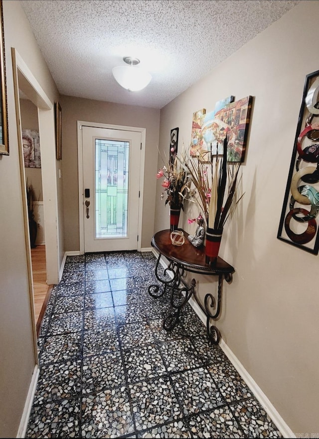 9 Apple Tree Cir, Little Rock, AR 72210 - entryway with baseboards, a textured ceiling, and tile patterned floors
