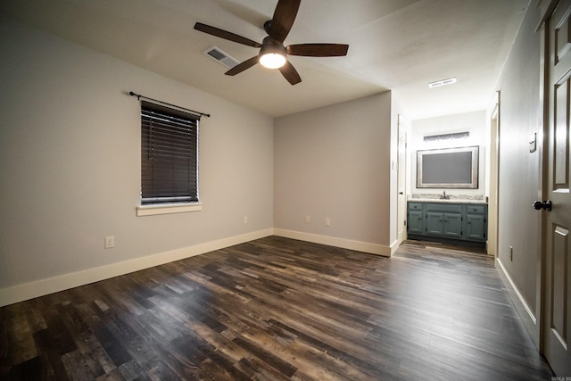 2330 Tyler St, Conway, AR 72034 - unfurnished bedroom featuring dark wood finished floors, a sink, and baseboards