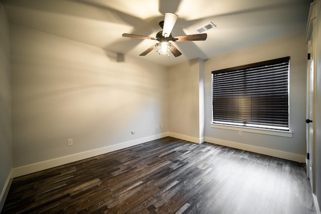 2330 Tyler St, Conway, AR 72034 - unfurnished room featuring ceiling fan, dark wood finished floors, and baseboards
