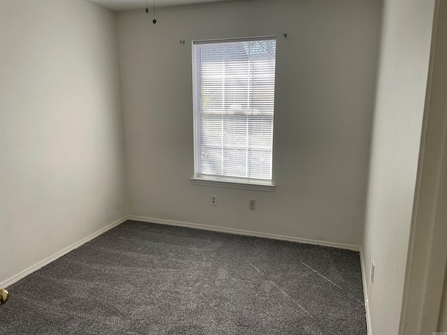1117 Troy Dr, Benton, AR 72019 - empty room with dark colored carpet, plenty of natural light, and baseboards