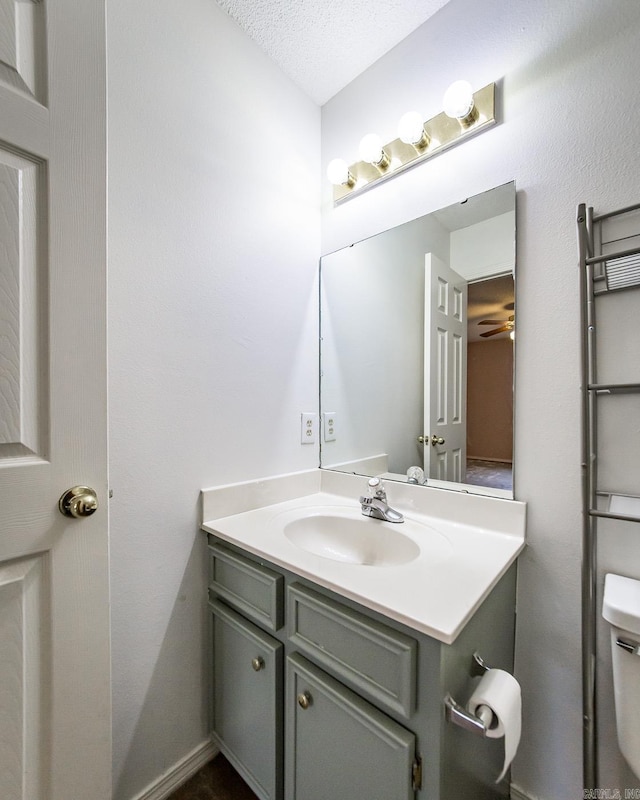 1117 Troy Dr, Benton, AR 72019 - bathroom featuring vanity, toilet, and ceiling fan
