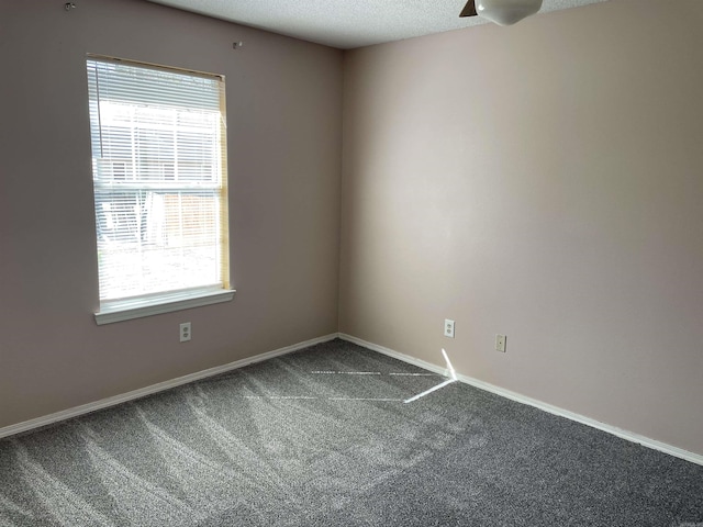 1117 Troy Dr, Benton, AR 72019 - empty room with dark carpet, plenty of natural light, baseboards, a ceiling fan, and a textured ceiling