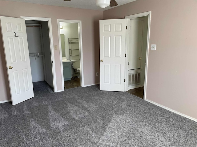 1117 Troy Dr, Benton, AR 72019 - unfurnished bedroom with dark colored carpet, baseboards, connected bathroom, and a closet