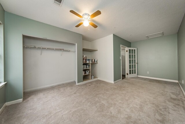 1117 Troy Dr, Benton, AR 72019 - unfurnished bedroom featuring attic access, carpet, a textured ceiling, ceiling fan, and baseboards