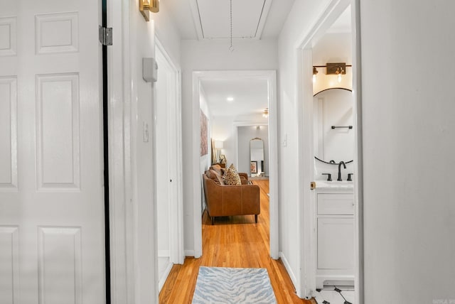 7521 Gable, Little Rock, AR 72205 - hall with light wood-type flooring, attic access, and a sink