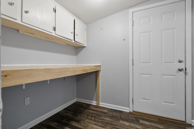 laundry area featuring dark wood-style flooring, baseboards, and an office area