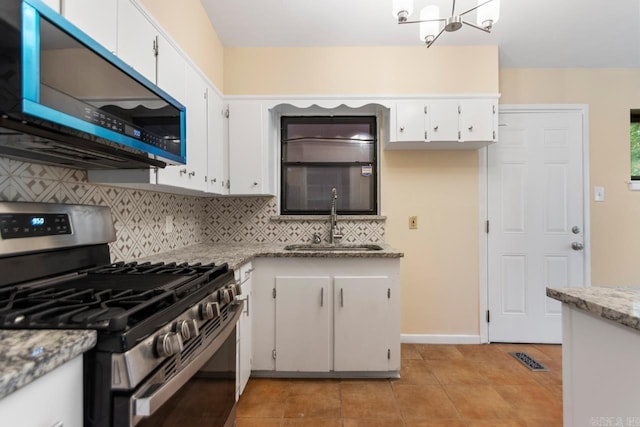 18 Woodcliff Cir, Little Rock, AR 72204 - kitchen featuring stainless steel gas range, a sink, tasteful backsplash, a chandelier, and white cabinetry