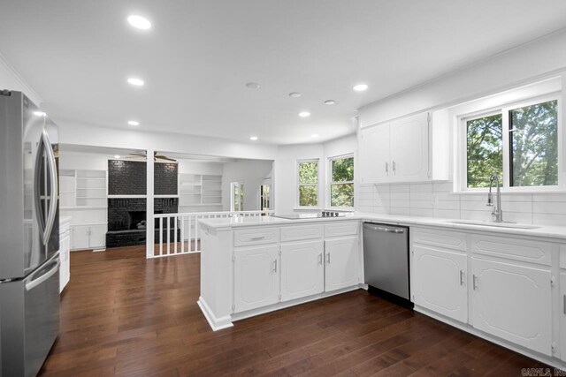 3 Poydras Dr, Little Rock, AR 72211 - kitchen featuring stainless steel appliances, a sink, a peninsula, white cabinetry, and recessed lighting