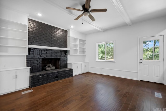 3 Poydras Dr, Little Rock, AR 72211 - unfurnished living room with beam ceiling, ceiling fan, dark wood finished floors, a brick fireplace, and built in shelves
