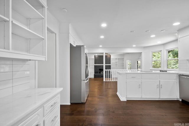 3 Poydras Dr, Little Rock, AR 72211 - kitchen featuring stainless steel appliances, a fireplace, white cabinets, dark wood-style flooring, and recessed lighting