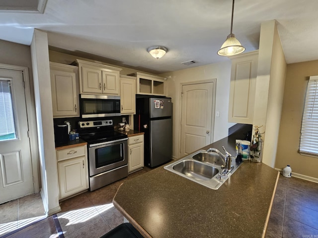 216 Plum Dr, Austin, AR 72023 - kitchen with stainless steel appliances, a sink, and dark countertops