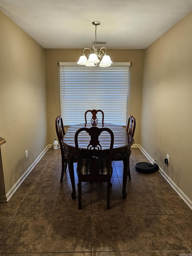 216 Plum Dr, Austin, AR 72023 - dining room with baseboards, dark tile patterned flooring, and a chandelier