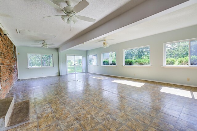 3508 Jack Mann Rd, Little Rock, AR 72210 - spare room featuring healthy amount of natural light, a textured ceiling, ceiling fan, baseboards, and stone finish flooring