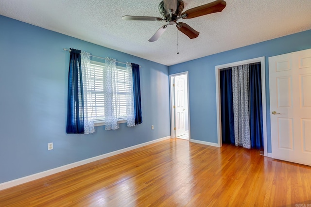 3508 Jack Mann Rd, Little Rock, AR 72210 - empty room with a textured ceiling, wood finished floors, a ceiling fan, and baseboards