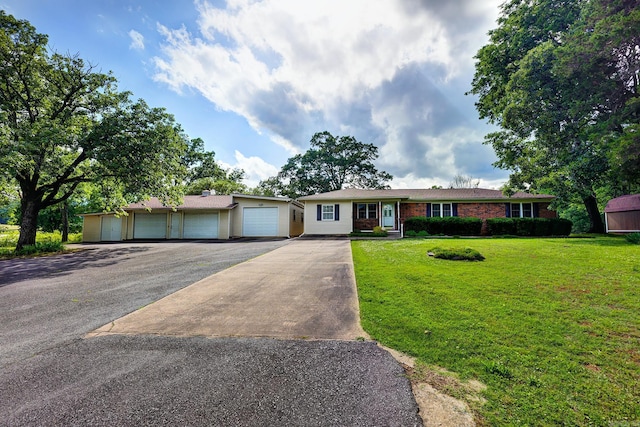 3508 Jack Mann Rd, Little Rock, AR 72210 - ranch-style house featuring driveway, a front yard, an attached garage, and brick siding