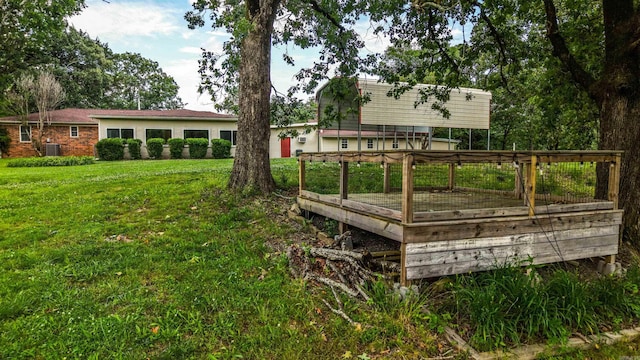 3508 Jack Mann Rd, Little Rock, AR 72210 - view of green lawn with a wooden deck and central AC unit
