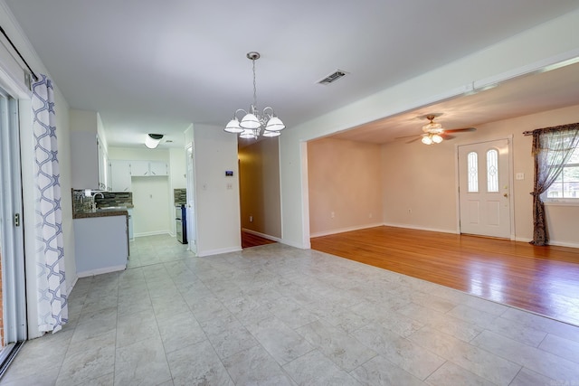 3508 Jack Mann Rd, Little Rock, AR 72210 - unfurnished living room with a chandelier, ceiling fan, baseboards, and a sink