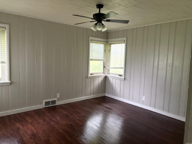 301 Coil, Steele, MO 63877 - empty room featuring dark wood finished floors, baseboards, a ceiling fan, and crown molding