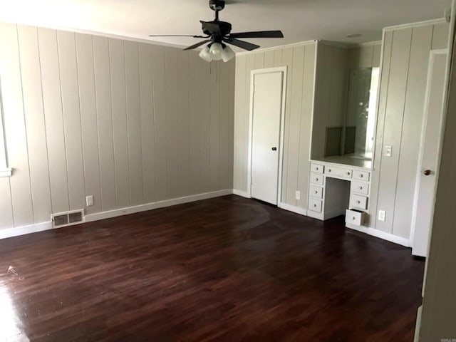 301 Coil, Steele, MO 63877 - unfurnished living room with ornamental molding, a ceiling fan, baseboards, dark wood finished floors, and wood walls