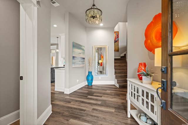 entrance foyer featuring baseboards, stairway, dark wood-style floors, recessed lighting, and a chandelier