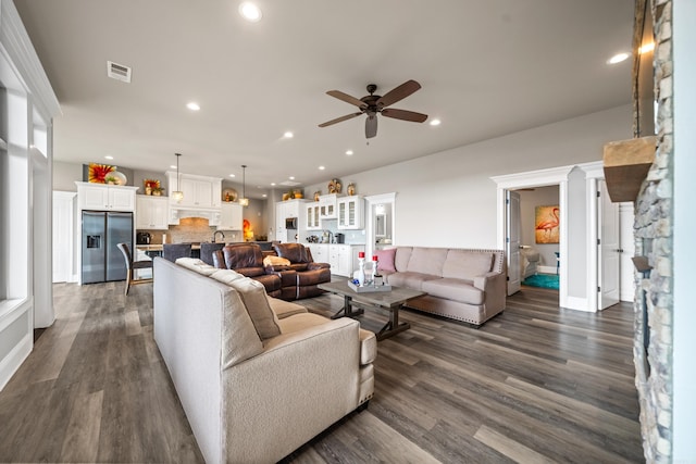 living area with ceiling fan, recessed lighting, and dark wood-style floors