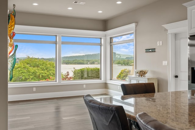 dining area featuring recessed lighting, wood finished floors, and baseboards