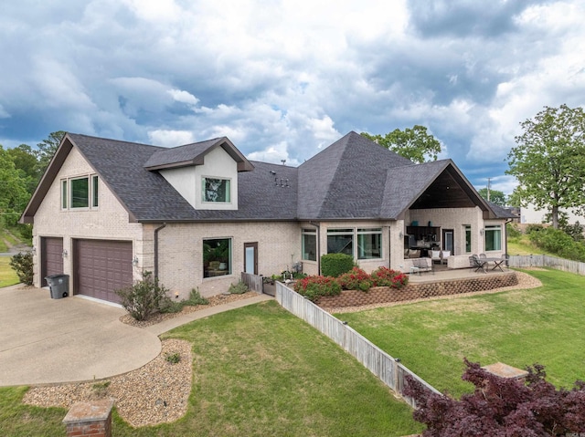 view of front of property featuring a garage, concrete driveway, brick siding, a shingled roof, and a patio