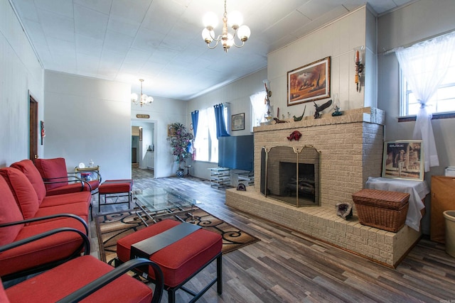 3110 Edison Ave, Benton, AR 72015 - living room featuring a chandelier, wood finished floors, ornamental molding, and a fireplace