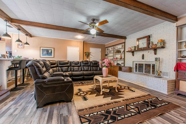 3110 Edison Ave, Benton, AR 72015 - living area with beamed ceiling, wood finished floors, ceiling fan, and a fireplace