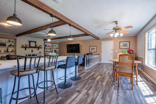 3110 Edison Ave, Benton, AR 72015 - kitchen featuring dark wood finished floors, ceiling fan, pendant lighting, a breakfast bar area, and beam ceiling