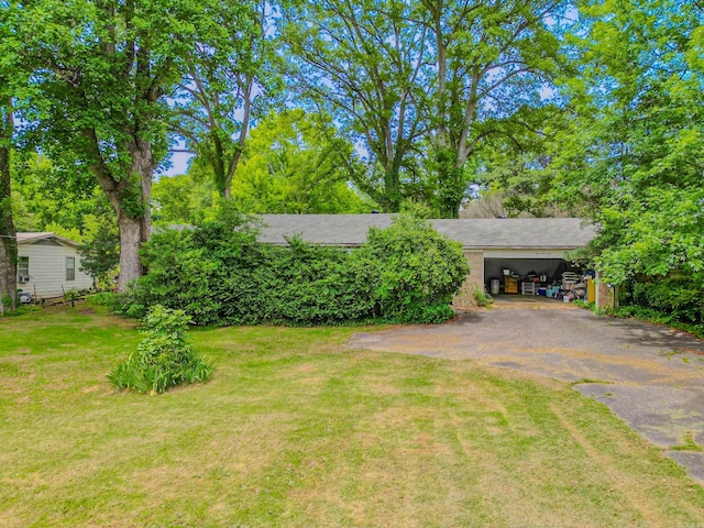 3106 Edison Ave, Benton, AR 72015 - view of green lawn with driveway and an attached carport