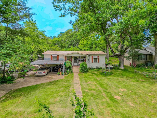 3106 Edison Ave, Benton, AR 72015 - view of front of house with a front yard, a carport, driveway, covered porch, and metal roof
