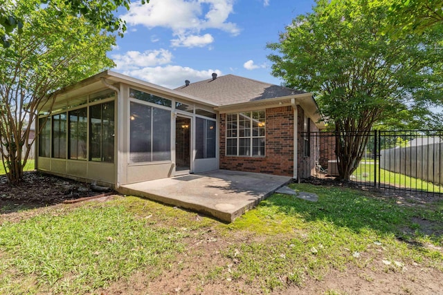 1045 Spatz Cir, Conway, AR 72034 - rear view of property with a sunroom, a patio area, brick siding, and a shingled roof