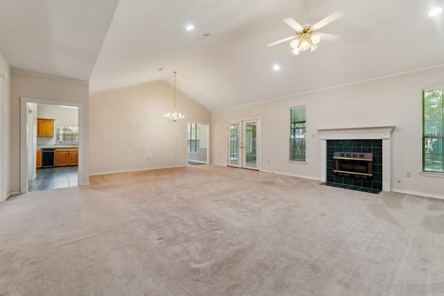 1045 Spatz Cir, Conway, AR 72034 - unfurnished living room featuring lofted ceiling, a tiled fireplace, baseboards, ceiling fan, and a chandelier