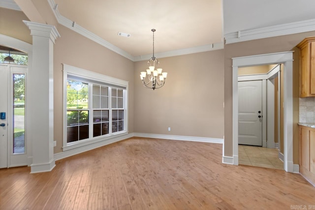 5611 Pear Tree Dr, Little Rock, AR 72206 - unfurnished dining area with ornate columns, light wood-style floors, a chandelier, ornamental molding, and baseboards