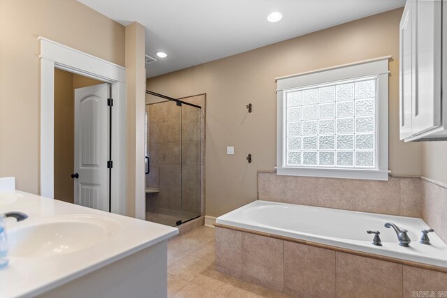 5611 Pear Tree Dr, Little Rock, AR 72206 - bathroom featuring a garden tub, a stall shower, vanity, tile patterned flooring, and recessed lighting