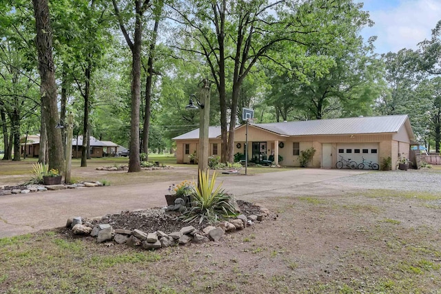234 Robin Ln, Walnut Ridge, AR 72476 - ranch-style home with a garage, asphalt driveway, and metal roof