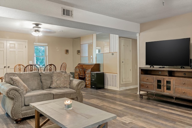 234 Robin Ln, Walnut Ridge, AR 72476 - living room featuring wood finished floors, a ceiling fan, a textured ceiling, and baseboards